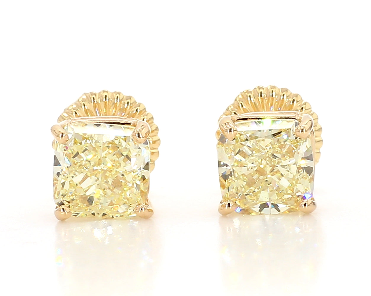 exceptional fancy light yellow cushion studs 6.04 carat