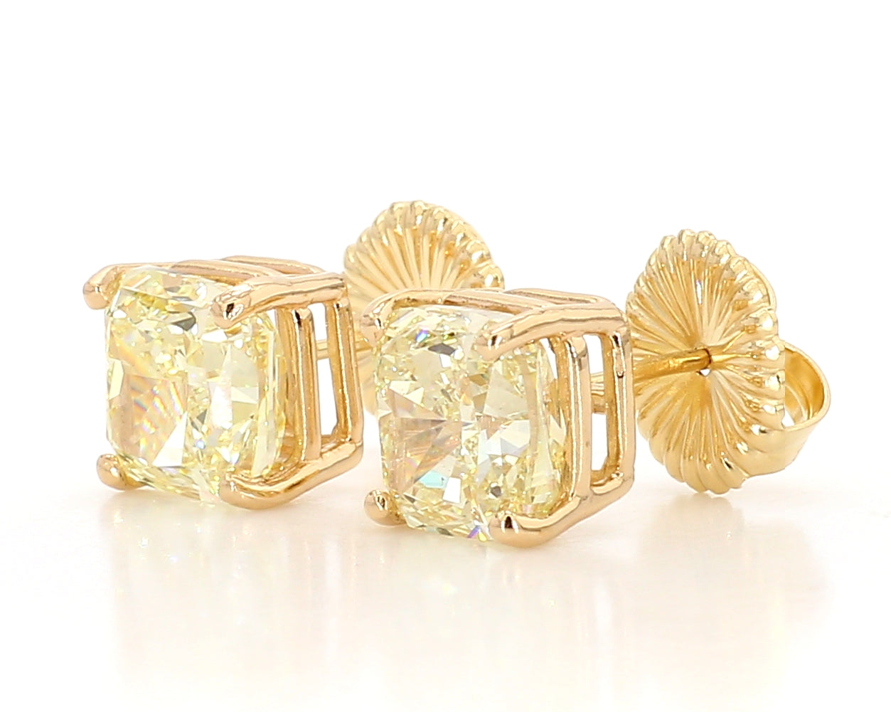 exceptional fancy light yellow cushion studs 6.04 carat