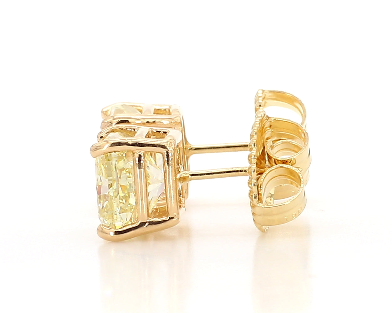 exceptional fancy light yellow cushion studs 6.04 carat