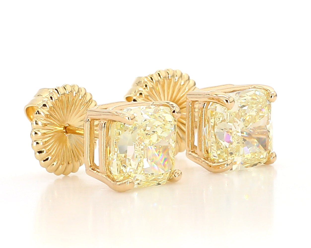 exceptional fancy light yellow cushion studs 6.04 carat