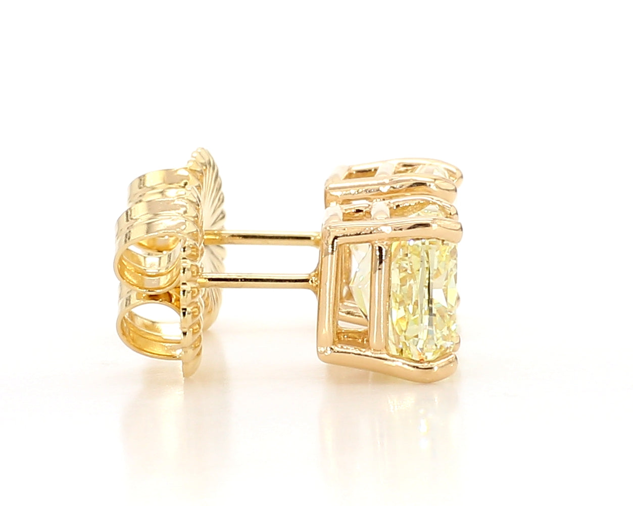 exceptional fancy light yellow cushion studs   6.04 carat